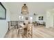 Open concept dining area with a wooden table and chairs, overlooking living room at 9749 Steele St, Thornton, CO 80229