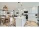 Bright kitchen with island, stainless steel appliances, and white cabinets at 9749 Steele St, Thornton, CO 80229