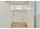 Basement laundry room with built-in shelving and vinyl flooring at 9749 Steele St, Thornton, CO 80229