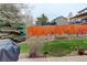 A serene backyard with lush lawn, well-maintained fence, and mature trees at 20715 Bridlewood Ln, Parker, CO 80138
