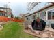 Lush backyard with a patio area, wooden fence, and a beautifully landscaped garden at 20715 Bridlewood Ln, Parker, CO 80138
