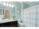 Well-lit bathroom with a granite countertop vanity, coordinating fixtures, and shower with curtain at 20715 Bridlewood Ln, Parker, CO 80138