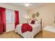 Inviting bedroom with a ceiling fan, featuring a comfortable bed and bright red accents at 20715 Bridlewood Ln, Parker, CO 80138