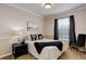 Cozy bedroom featuring neutral tones, a comfortable bed, and ample natural light from the window at 20715 Bridlewood Ln, Parker, CO 80138
