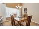 Formal dining room features a glass-topped table, chandelier, and views to an open kitchen area at 20715 Bridlewood Ln, Parker, CO 80138