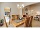 Dining room features a glass-topped table with views to the kitchen and living room at 20715 Bridlewood Ln, Parker, CO 80138