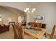 Open-concept dining room with glass-topped table adjacent to the living room at 20715 Bridlewood Ln, Parker, CO 80138