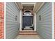 Inviting covered front porch with stylish decor leading to a modern front door at 20715 Bridlewood Ln, Parker, CO 80138