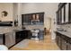 Modern kitchen features dark cabinetry, stainless steel appliances, and hardwood flooring at 20715 Bridlewood Ln, Parker, CO 80138