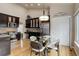 Stylish kitchen with black cabinets, stainless steel appliances, and a glass-top dining table at 20715 Bridlewood Ln, Parker, CO 80138
