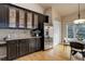 Eat-in kitchen features dark cabinets, stainless steel appliances, and a breakfast nook with natural light at 20715 Bridlewood Ln, Parker, CO 80138