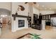 Open floor plan with fireplace and dark cabinets, connecting the kitchen to the living room at 20715 Bridlewood Ln, Parker, CO 80138
