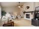 Cozy living room features neutral tones, a vaulted ceiling, and a traditional fireplace at 20715 Bridlewood Ln, Parker, CO 80138
