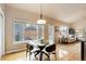 Bright living room with breakfast nook, lots of natural lighting, and view of the backyard at 20715 Bridlewood Ln, Parker, CO 80138