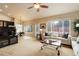 Spacious living room with neutral tones, natural light, and open layout to the breakfast nook at 20715 Bridlewood Ln, Parker, CO 80138
