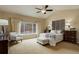 Large primary bedroom with vaulted ceiling, large windows, and decorative wall art at 20715 Bridlewood Ln, Parker, CO 80138