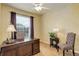 Dedicated office space with natural light, featuring a classic wooden desk and comfortable seating at 20715 Bridlewood Ln, Parker, CO 80138