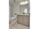 Bathroom featuring a large mirror, granite countertop and shower with polka dot curtain at 16818 E 119Th Ave # A, Commerce City, CO 80022