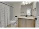Bathroom featuring a large mirror, granite countertop and shower with polka dot curtain at 16818 E 119Th Ave # A, Commerce City, CO 80022