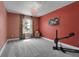 Bedroom with colorful walls, plush gray carpet, and a decorative chandelier at 16818 E 119Th Ave # A, Commerce City, CO 80022