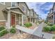 Street view of attractive townhomes with well-maintained landscaping and sidewalks at 16818 E 119Th Ave # A, Commerce City, CO 80022