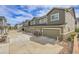 Street view of several townhome garages with manicured landscaping and a blue sky at 16818 E 119Th Ave # A, Commerce City, CO 80022