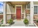 Inviting front porch with string lights, cheerful flowers, a welcome mat, and cozy hammock at 16818 E 119Th Ave # A, Commerce City, CO 80022