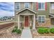Charming front porch with colorful flowers, cozy hammock, and inviting entrance at 16818 E 119Th Ave # A, Commerce City, CO 80022