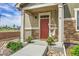 Charming front porch decorated with string lights, vibrant flowers, and a cozy hammock swing at 16818 E 119Th Ave # A, Commerce City, CO 80022