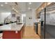 Gourmet kitchen with modern cabinetry, stainless steel appliances, and a large island for dining at 16818 E 119Th Ave # A, Commerce City, CO 80022