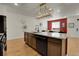 Open kitchen with a large island, modern appliances, and stylish fixtures at 16818 E 119Th Ave # A, Commerce City, CO 80022