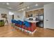 This is a view of the kitchen with wooden cabinets, stainless steel appliances, and large island with seating at 16818 E 119Th Ave # A, Commerce City, CO 80022