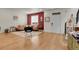 Open-concept living area with hardwood floors, stylish furniture, and a vibrant accent wall at 16818 E 119Th Ave # A, Commerce City, CO 80022