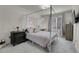 Cozy bedroom featuring a four-poster bed, soft lighting, and a comfortable workspace at 16818 E 119Th Ave # A, Commerce City, CO 80022