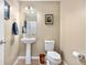Powder room with modern fixtures, pedestal sink, framed art and vinyl flooring at 16351 Askins Loop, Parker, CO 80134