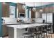 Modern kitchen features a large island, stainless steel appliances, and stylish pendant lighting at 16351 Askins Loop, Parker, CO 80134