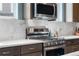 Elegant kitchen featuring quartz countertops, stainless steel appliances, and modern cabinetry at 16351 Askins Loop, Parker, CO 80134