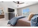 Main bedroom with a TV, dresser, chair, and an ensuite bathroom at 16351 Askins Loop, Parker, CO 80134