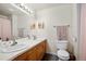 Bright bathroom featuring a double sink vanity with modern lighting and neutral-colored accessories at 2773 S Lansing Way, Aurora, CO 80014