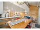 Open floor plan with a view of the living room, kitchen, and dining area with wood paneling at 2773 S Lansing Way, Aurora, CO 80014