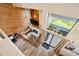 Open living room featuring wood paneling, a fireplace, and bright natural light from large windows at 2773 S Lansing Way, Aurora, CO 80014