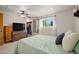 This main bedroom features a TV, ceiling fan, a large window and an organized walk-in closet at 2773 S Lansing Way, Aurora, CO 80014