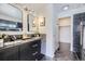 Elegant bathroom with a walk-in shower and double vanity at 16424 E 107Th Pl, Commerce City, CO 80022