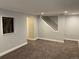 Neutral basement space with carpet, small window, and stairway at 7565 S Cove Cir, Centennial, CO 80122