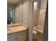 Bright bathroom featuring a shower and bathtub, neutral color scheme, and a large mirror over the sink at 7565 S Cove Cir, Centennial, CO 80122