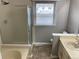 Bathroom with frosted glass shower door, tile flooring, and updated vanity at 7565 S Cove Cir, Centennial, CO 80122