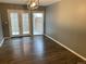 Bright dining area with double glass doors and contemporary light fixture at 7565 S Cove Cir, Centennial, CO 80122