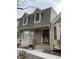 Charming townhouse featuring a decorative front door,dormer windows, and brick accents at 7565 S Cove Cir, Centennial, CO 80122