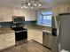 Modern kitchen with stainless steel appliances, granite countertops, and updated fixtures at 7565 S Cove Cir, Centennial, CO 80122