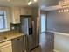 Updated kitchen with stainless steel refrigerator and a view into the dining area at 7565 S Cove Cir, Centennial, CO 80122